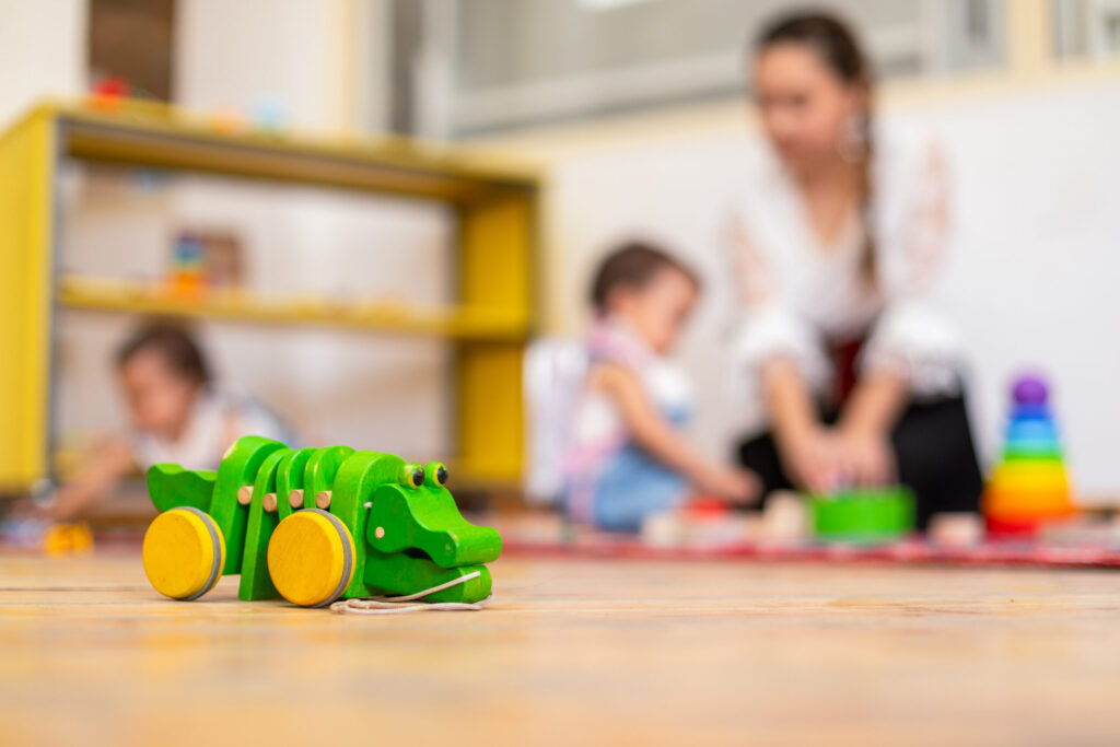 Wooden toy crocodile at a Toronto daycare, symbolizing a regulated CWELCC program that parents can look up in Ontario’s child care violations registry.