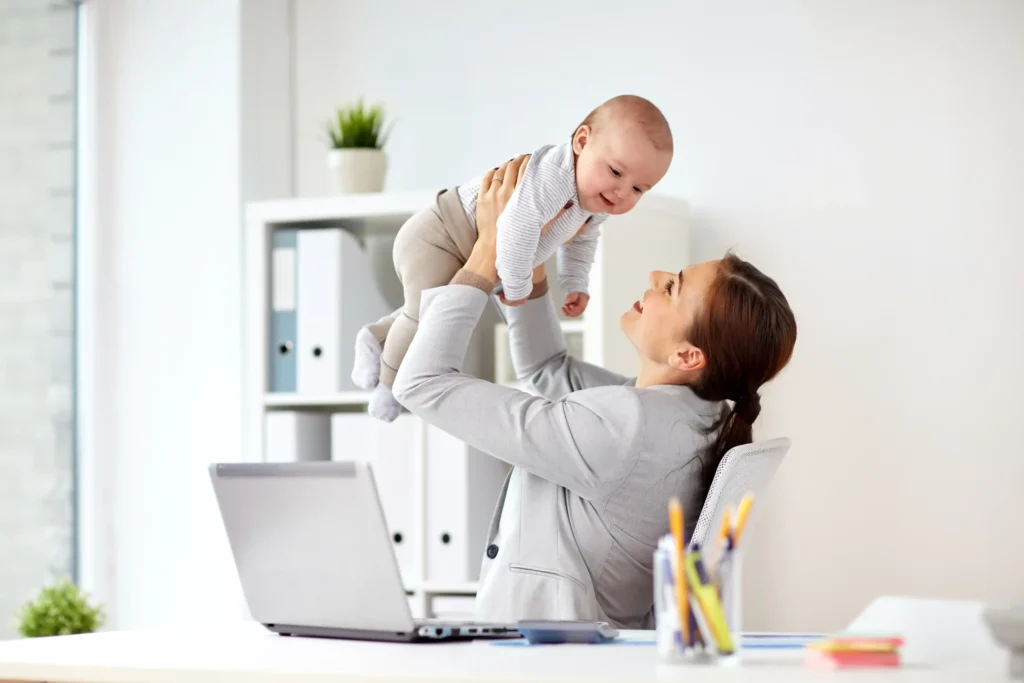 Working Ontario mom holding baby in office, balancing career and maternity leave under EI 2026 updates