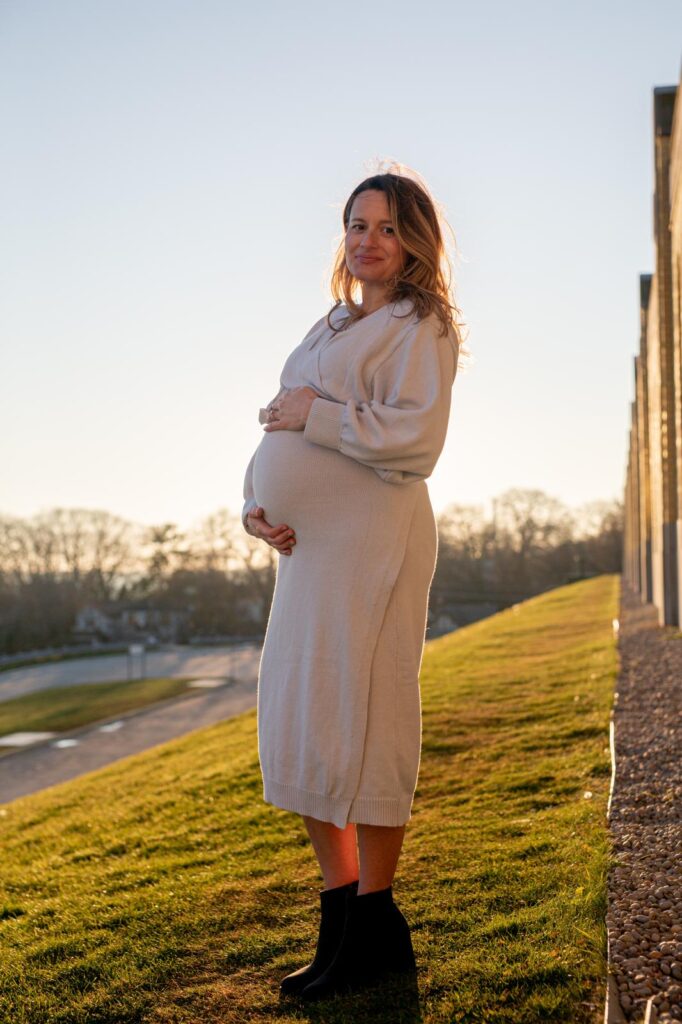 Nicole Kingston, the founder of Toronto Baby Guide and author of The Ultimate Guide to Having a Baby in Toronto holding her baby bump at that beaches water treatment plant.
