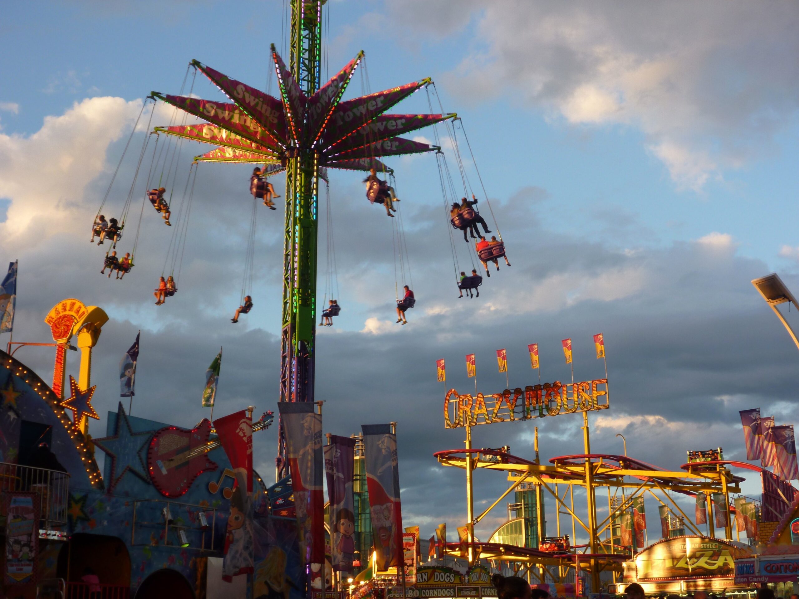 CNE fairgrounds with rides and crowds on a summer evening