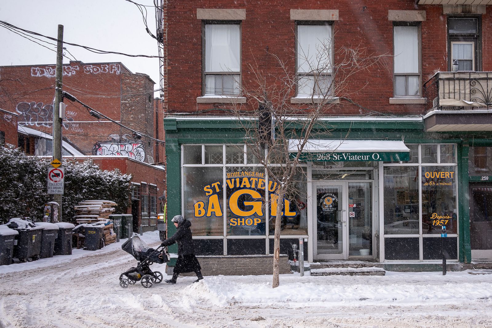A stroller on a snowy street in winter
