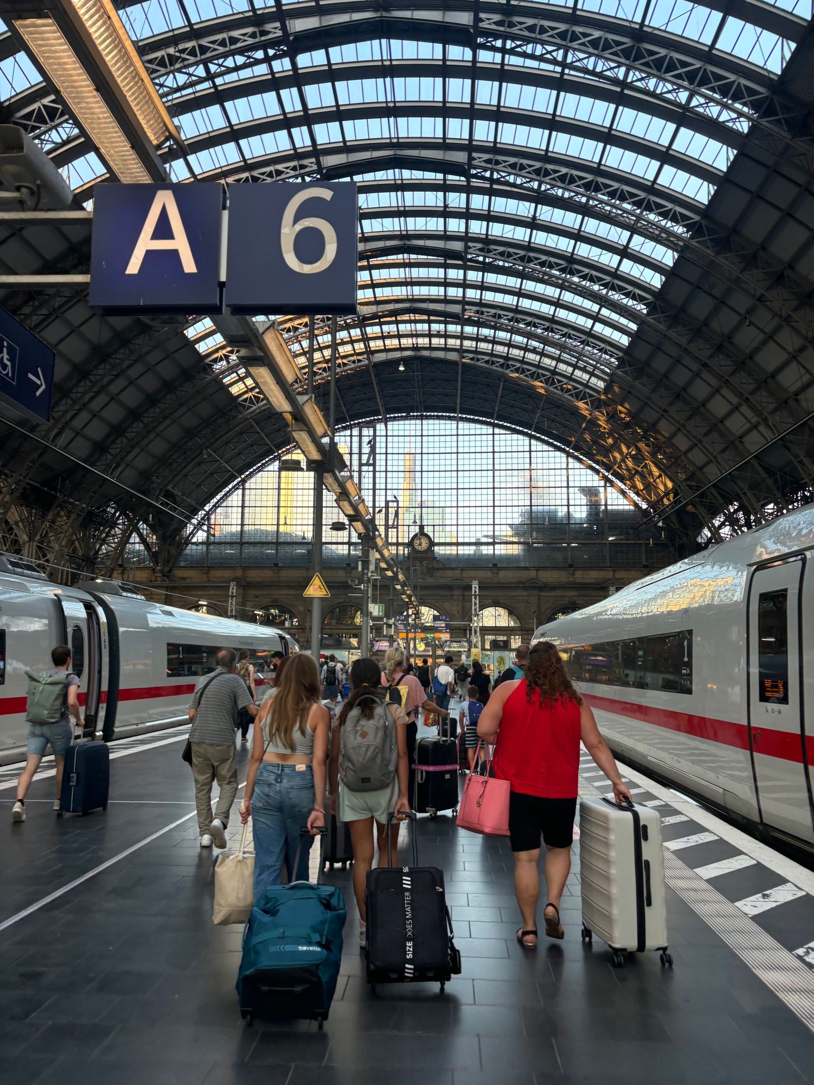 Travellers with luggage inside a train station